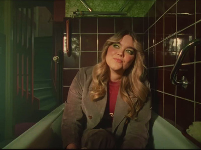 a woman sitting in a bathtub in a bathroom