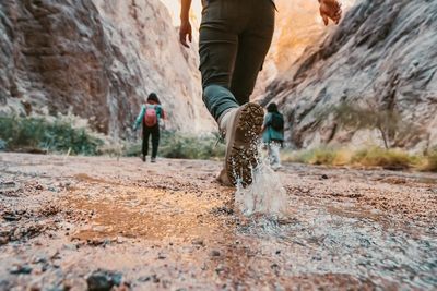 a man walking through a canyon in the desert