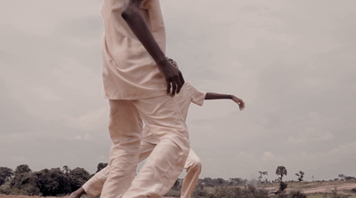 a man in a white shirt and tan pants