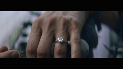 a woman's hand with a diamond ring on it