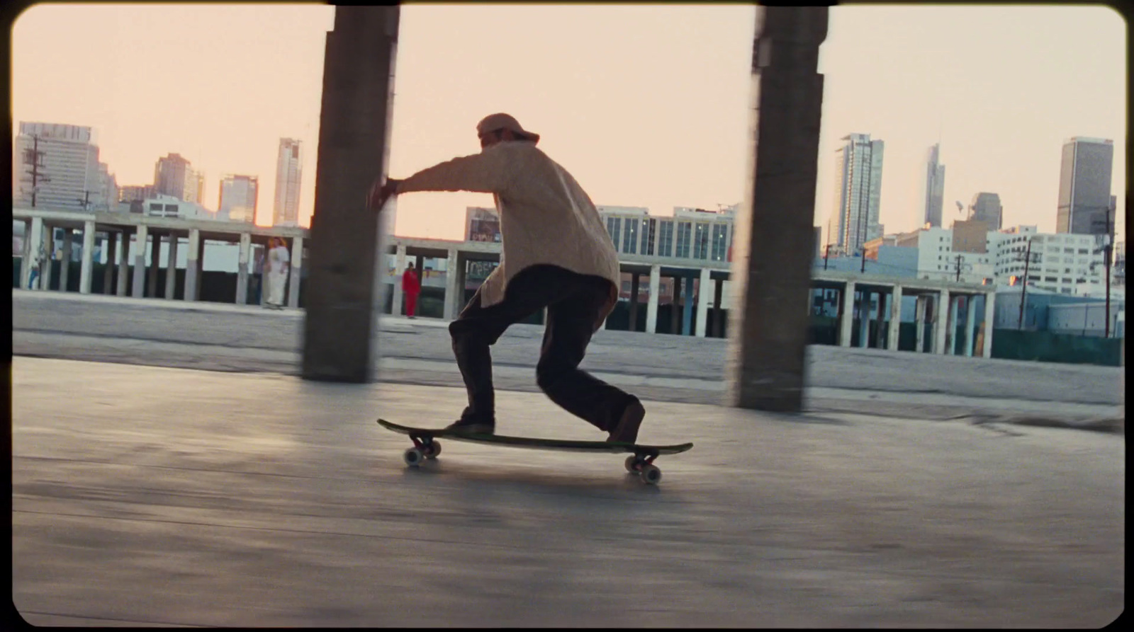 a man riding a skateboard down a sidewalk