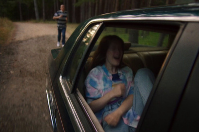 a woman sitting in the back seat of a car