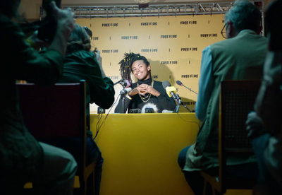 a man sitting at a table with a microphone