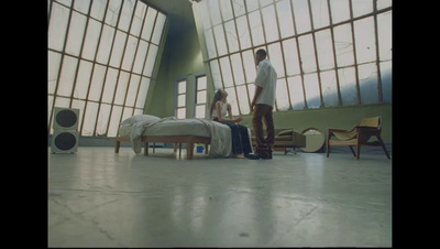 a man standing next to a bed in a room