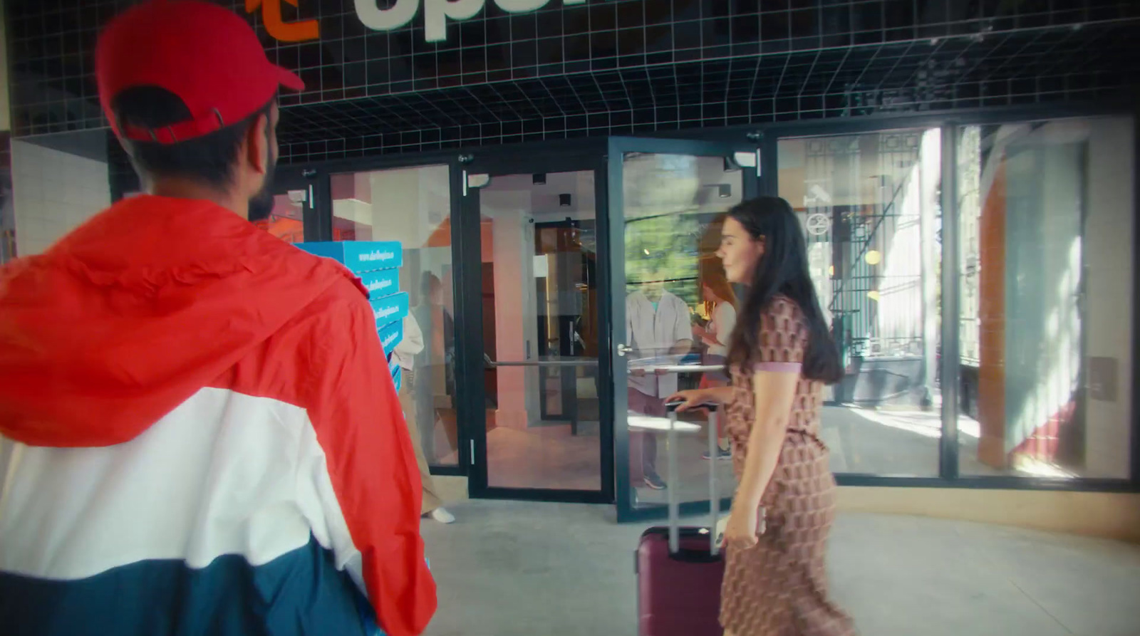 a man and a woman walking in front of a store