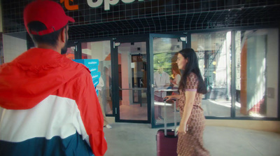 a man and a woman walking in front of a store