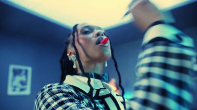 a woman with dreadlocks standing in a room