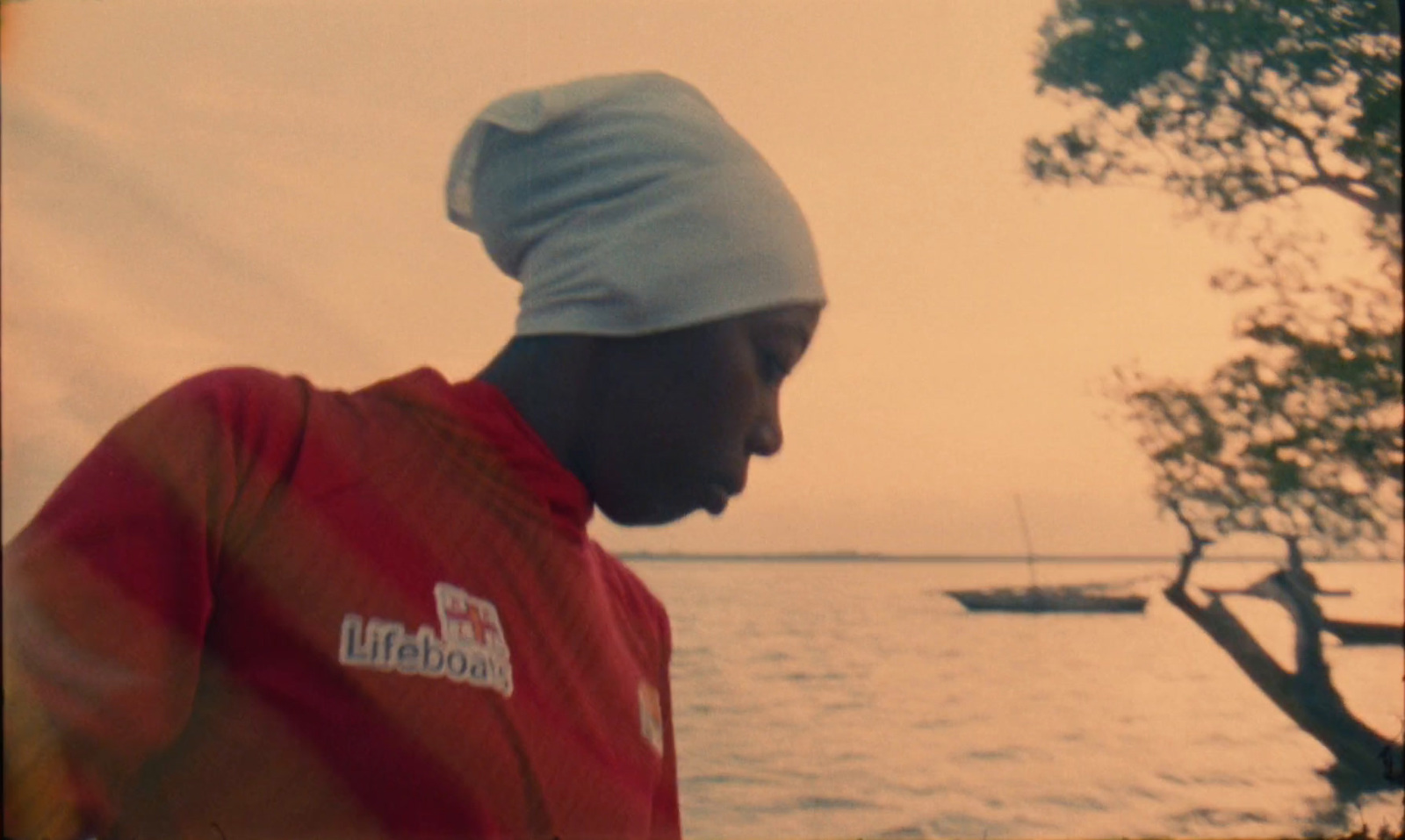 a man standing in front of a body of water