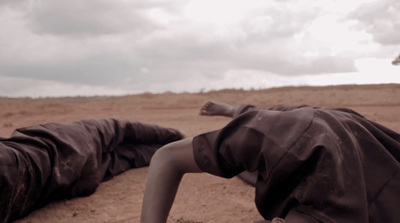 a person laying on the ground in the desert