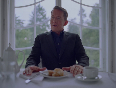 a man sitting at a table with a plate of food