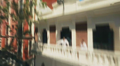 a blurry photo of people walking on a balcony