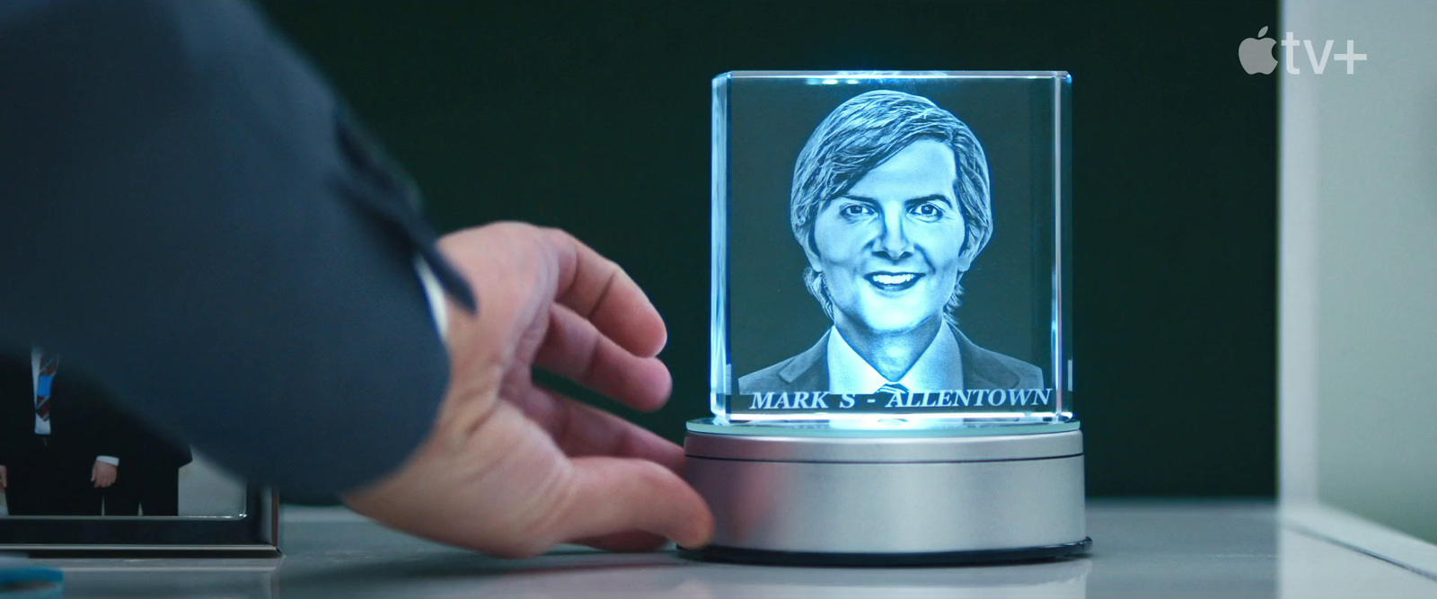 a person holding a glass block with a picture of a woman on it