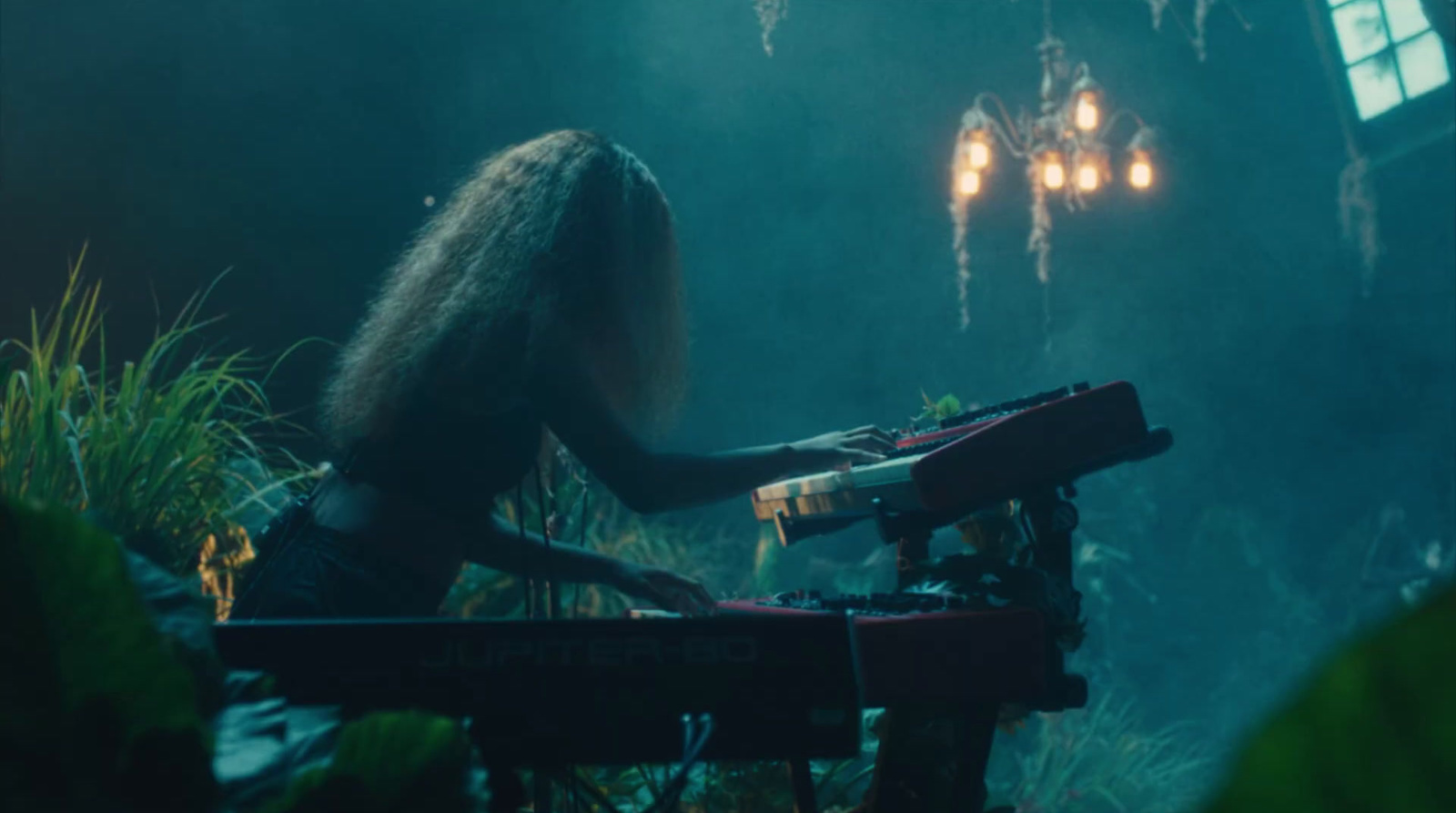 a woman with long hair playing a keyboard