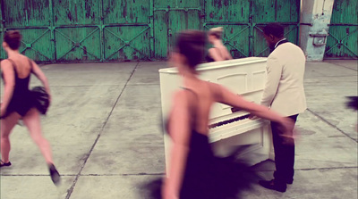 a man and a woman are playing the piano