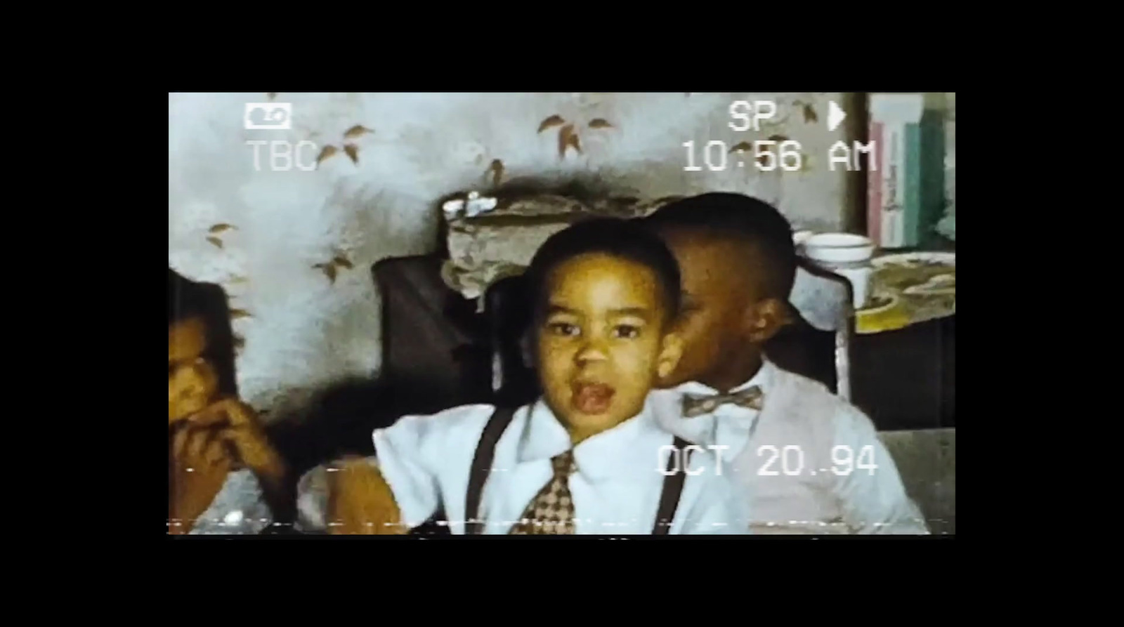 a young boy in a white shirt and tie