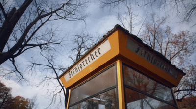 a yellow box sitting in the middle of a park