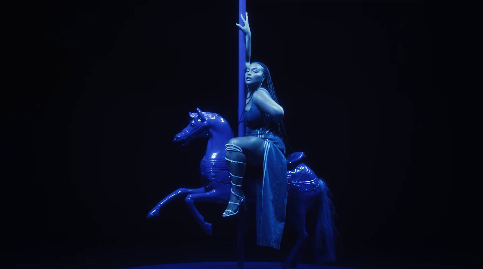 a woman riding on the back of a blue horse