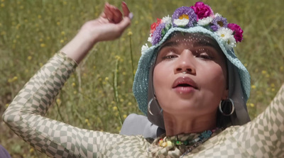 a woman wearing a hat with flowers on her head