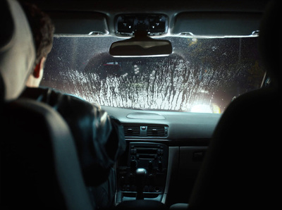 a man driving a car in the dark