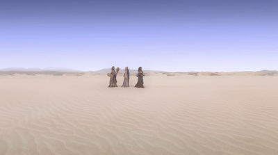 a group of people standing in the middle of a desert