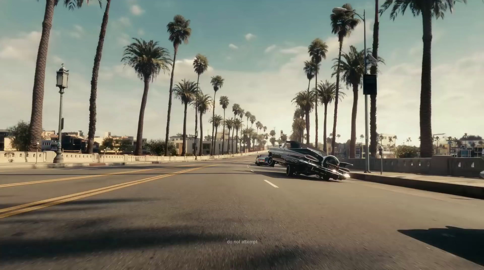 a car driving down a street next to palm trees