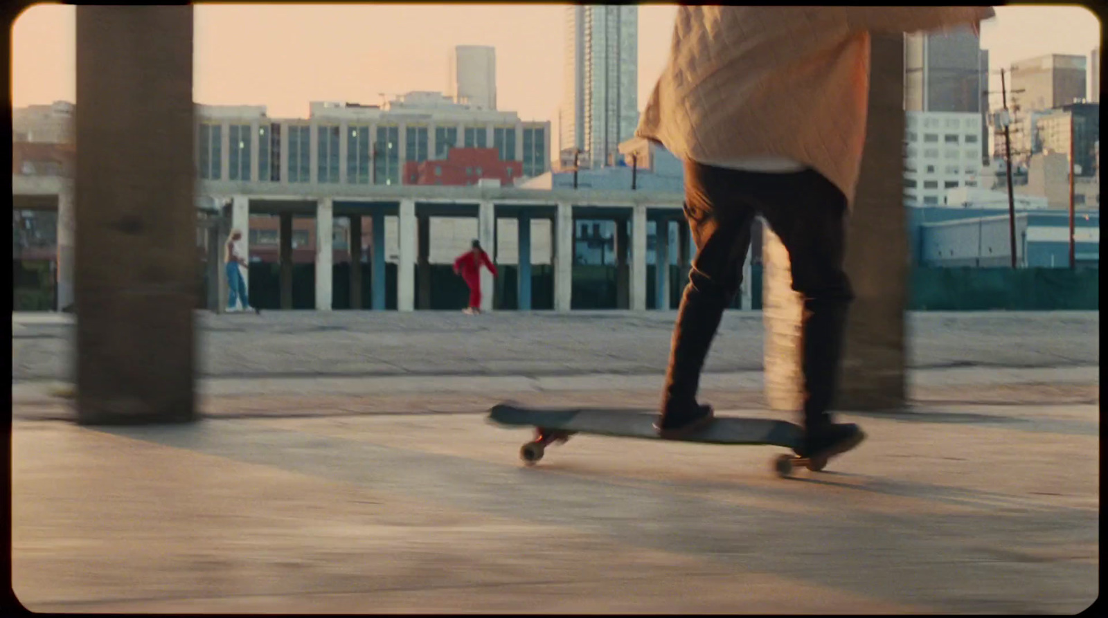 a man riding a skateboard down a sidewalk