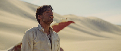 a man standing in front of a mountain