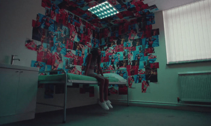 a person sitting on a bed in a room