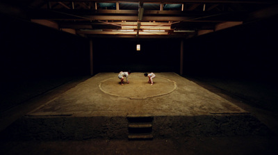 a couple of men standing on top of a wrestling ring