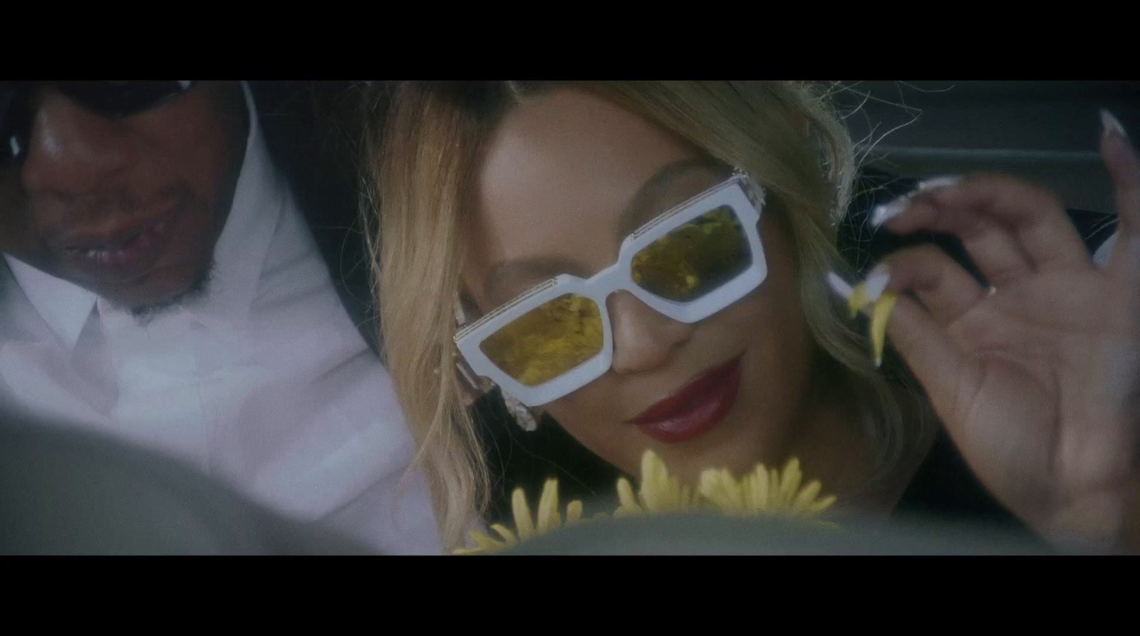 a woman wearing sun glasses in a car