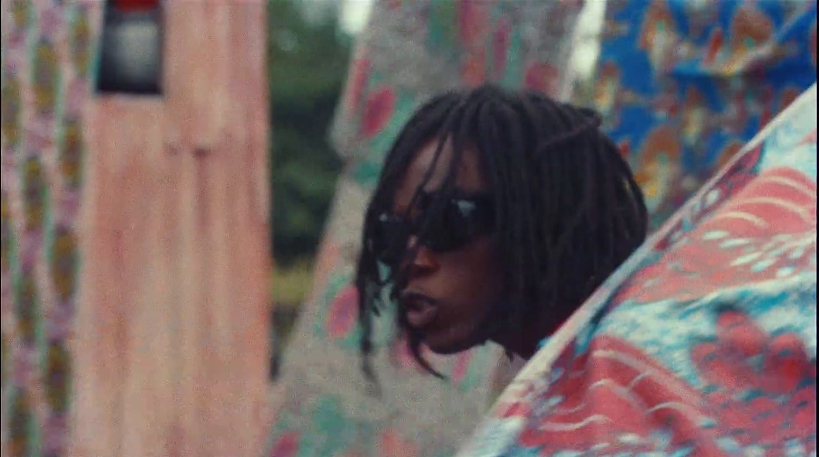 a man with dreadlocks is wrapped in a blanket