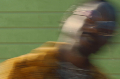 a blurry image of a man holding a baseball bat