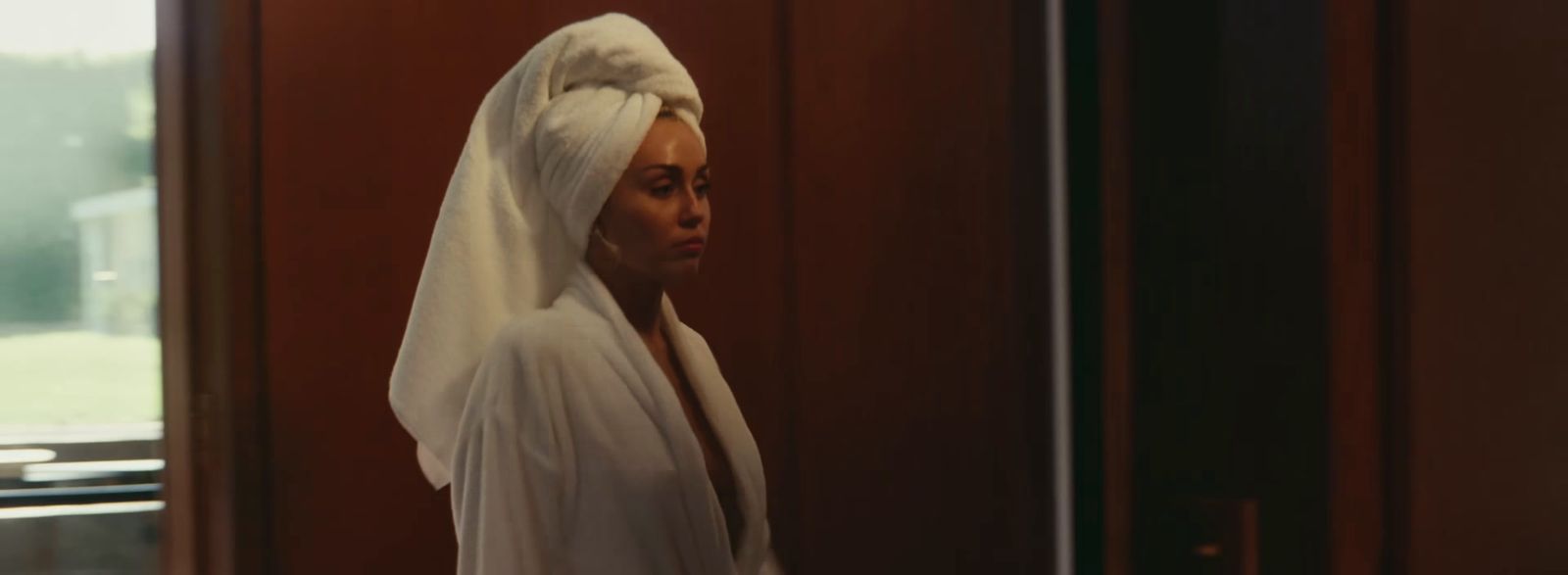 a woman in a white veil standing in front of a door