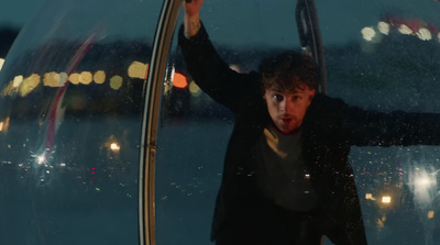 a man standing in front of a glass ball