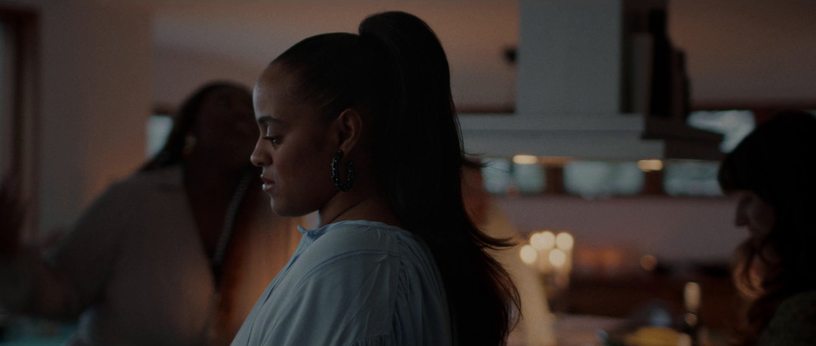 a woman standing in a kitchen next to a window