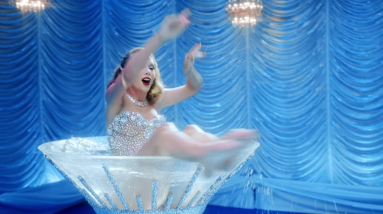 a baby in a white bodysuit floating in a crystal bowl