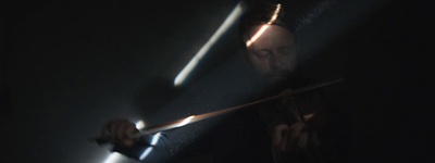 a man holding a sword in the dark