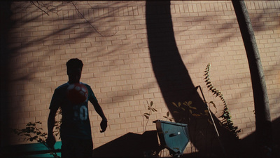 a man standing in front of a brick wall