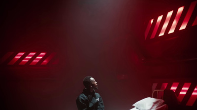 a man sitting on a bed in a dark room