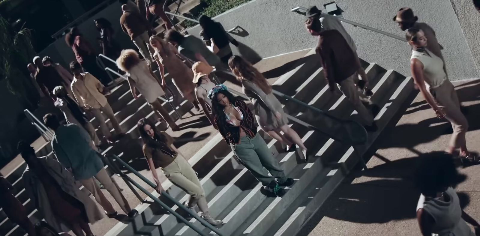 a group of people walking down a street next to each other