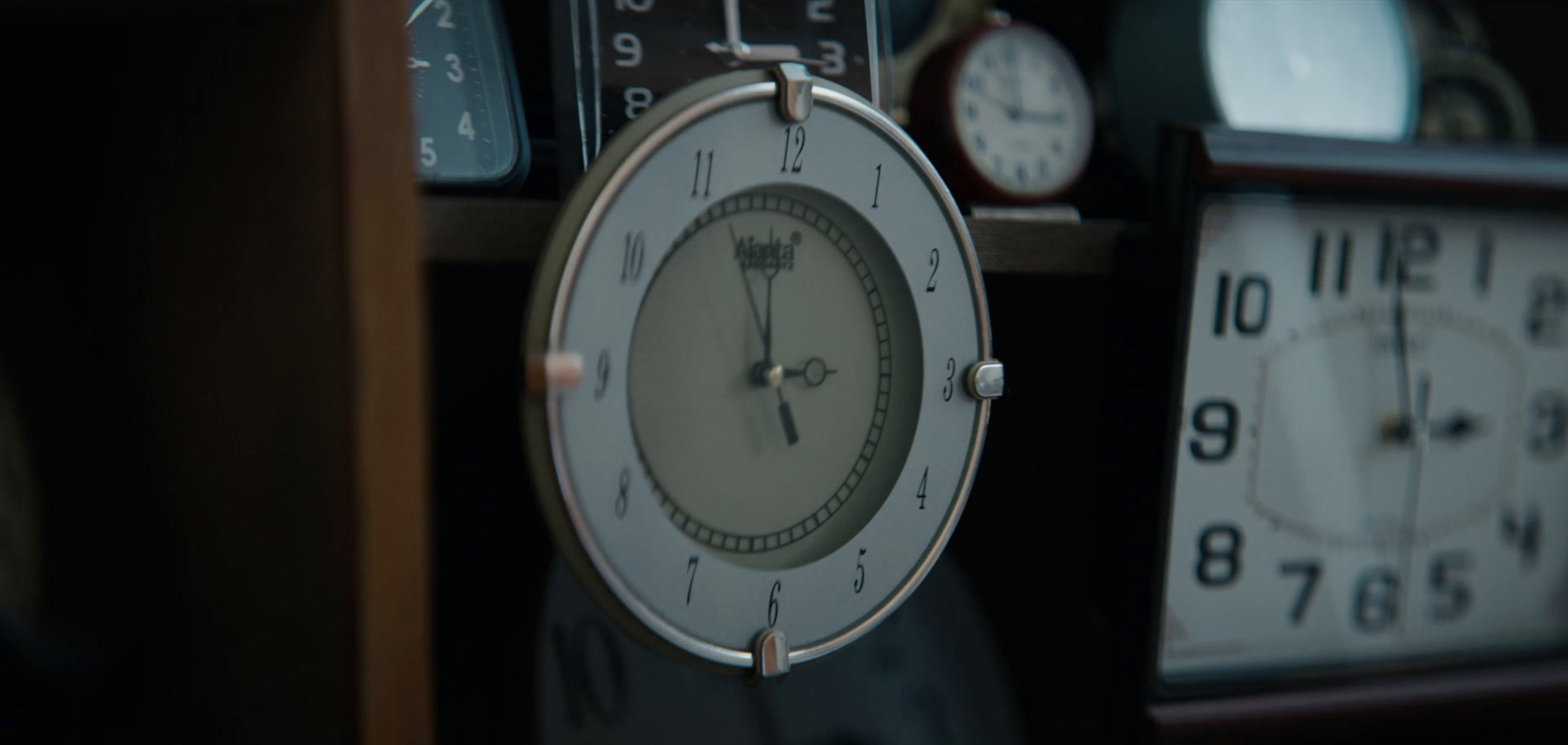 a close up of a clock on a shelf