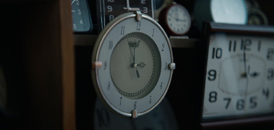 a close up of a clock on a shelf