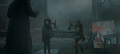 a group of people standing around in a dark room