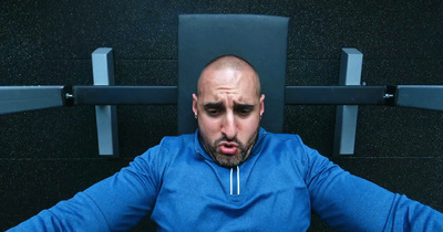 a man with a bald head sitting in a chair