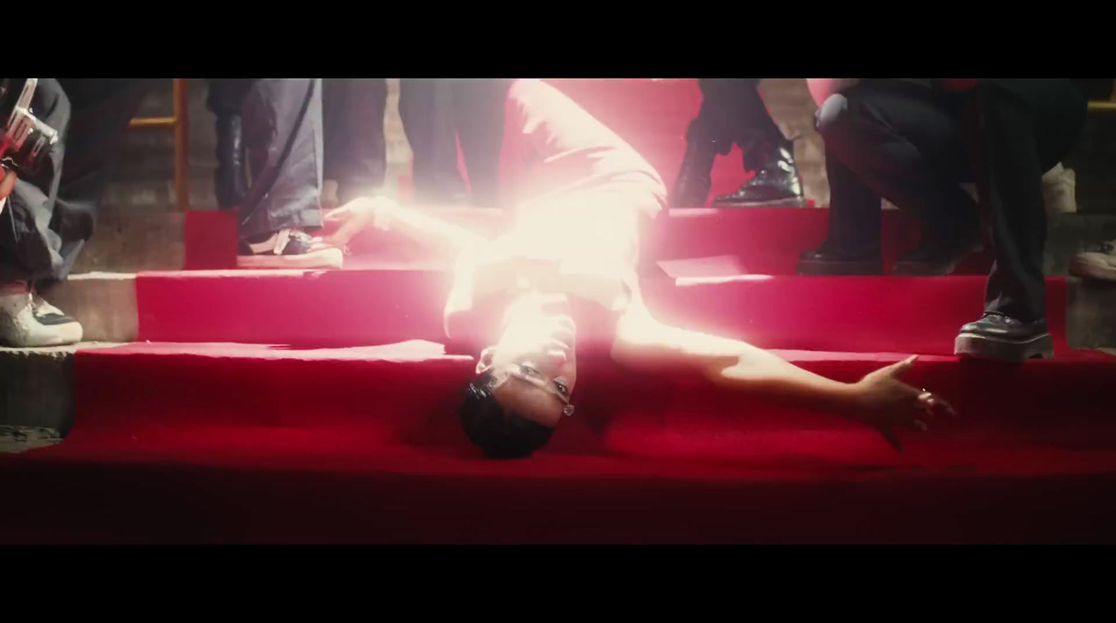 a person laying down on a red carpet