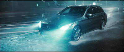 a car driving through a flooded street at night