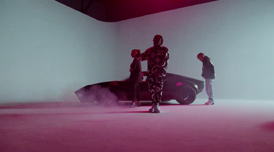 a group of people standing around a car in a room