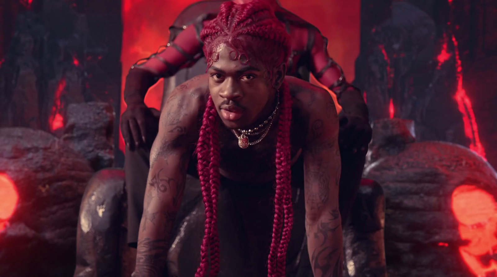 a man with red dreadlocks sitting on a chair