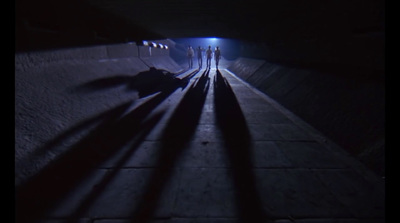 a group of people standing in a dark tunnel