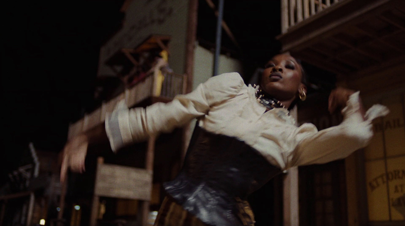 a woman jumping in the air in front of a building